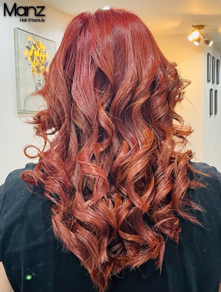 Deep red colour with soft curls and shine, styled at Manz Hair and Beauty