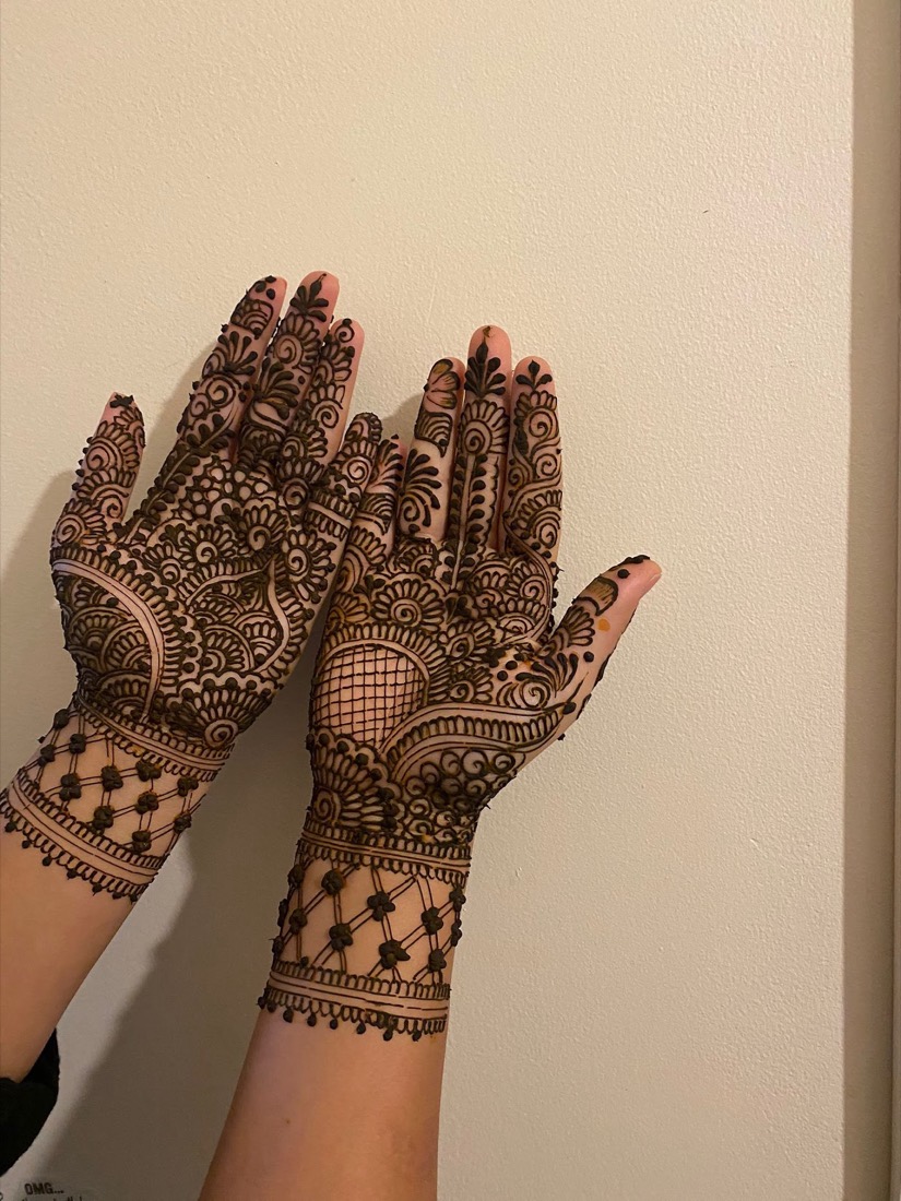 Intricate bridal mehndi henna design on both hands, done at Manz Hair and Beauty