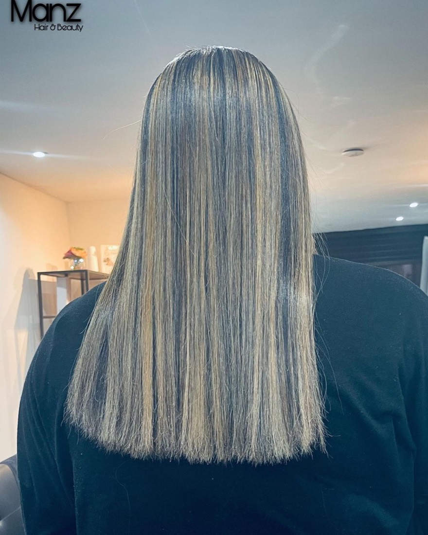 Blonde highlights on long, sleek straightened hair at Manz Hair and Beauty